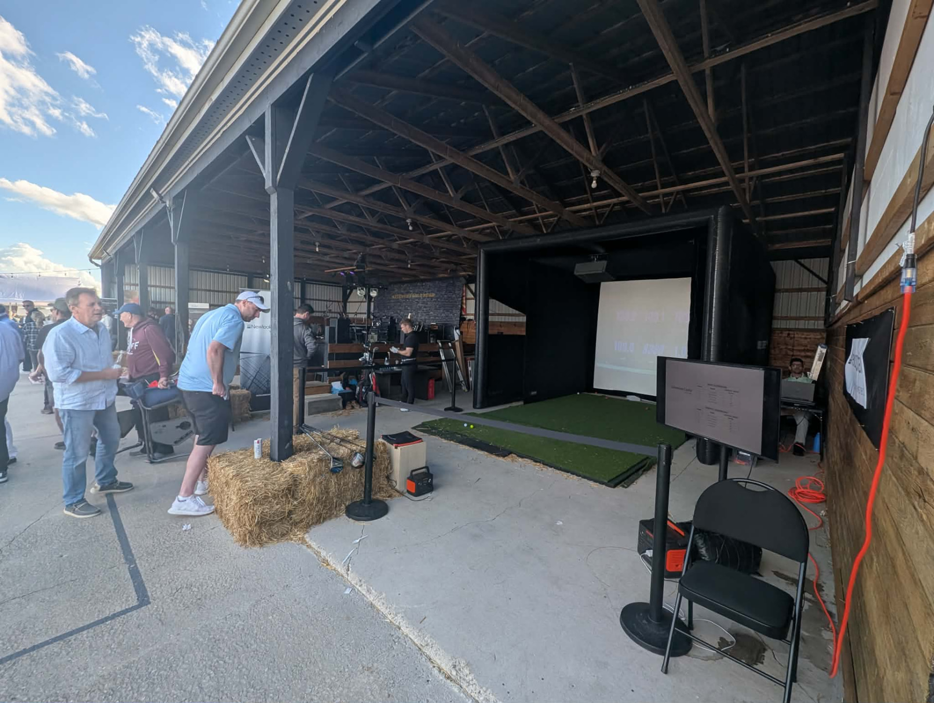 Outdoor event simulator bay under a covered pavilion
