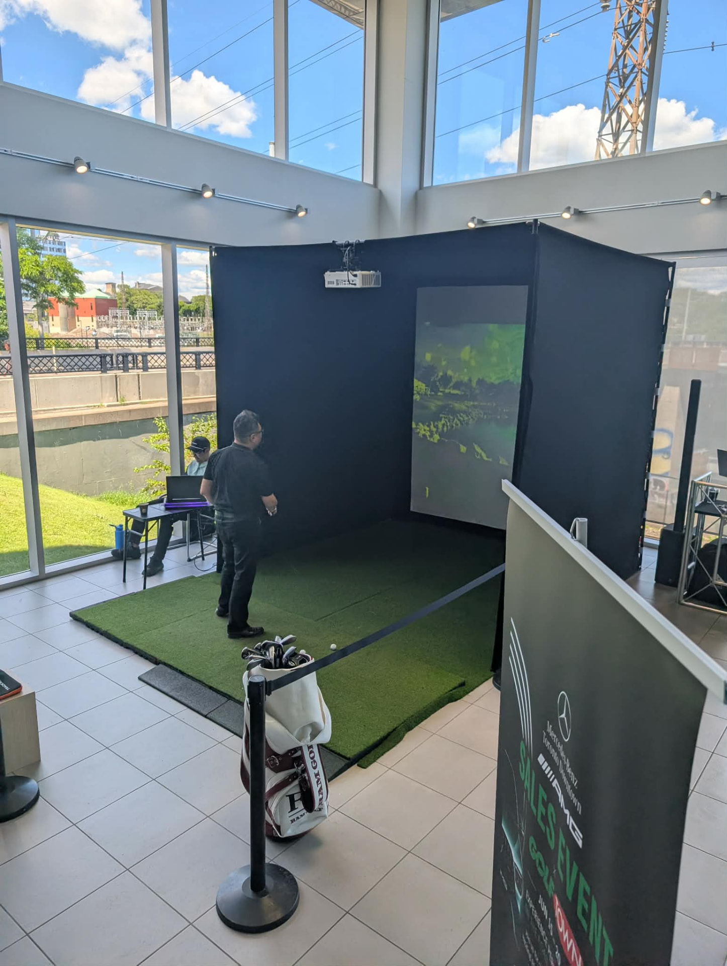 Full simulator rental in a glass-walled dealership atrium