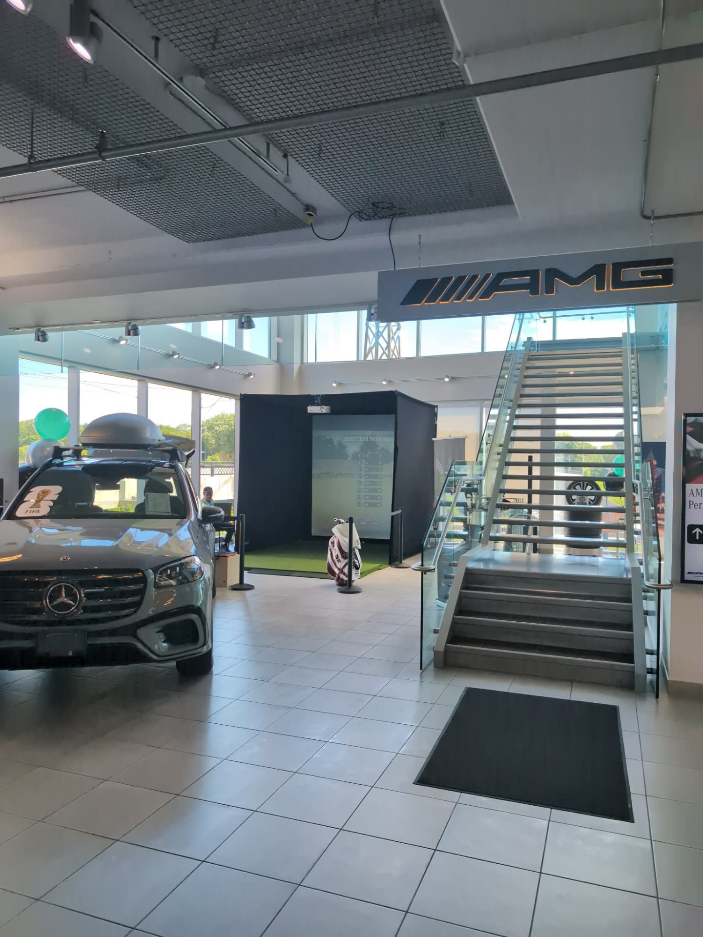 Mobile Greens simulator activation inside a modern Mercedes-Benz AMG showroom